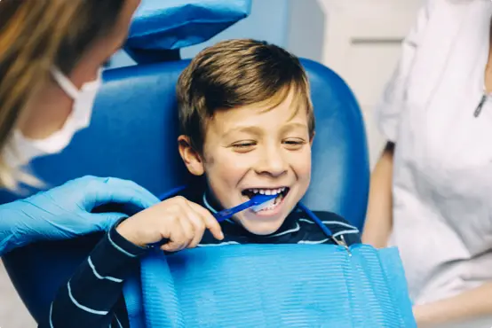 young boy at the dentist practicing brushing